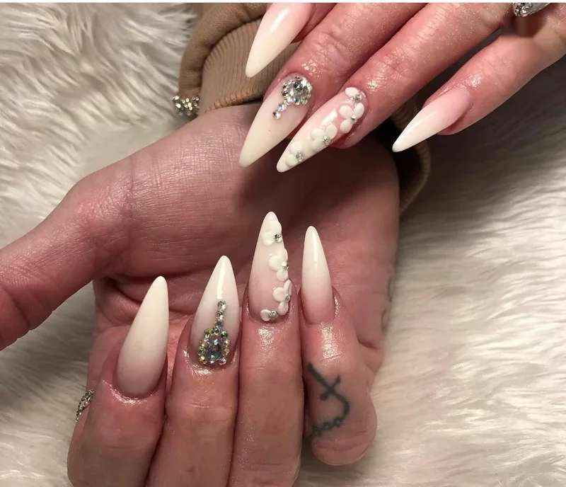 Nude ombré stiletto acrylic nails with diamantés and 3D flowers by Nailed by Ellie